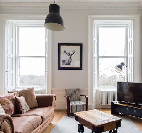 Settle in and stretch out on the leather sofa in the light-filled living room
