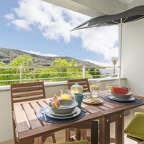 Take in the views over Funchal and the ocean from your private balcony