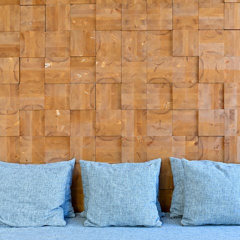 Admire the unique wood-panelled wall in the living room