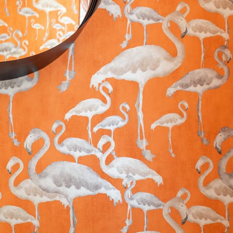 Freshen up in the bathroom alongside the quirky flamingo-print wallpaper