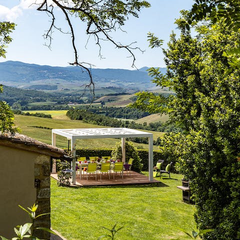 Dine under the shaded pergola in company of rolling countryside