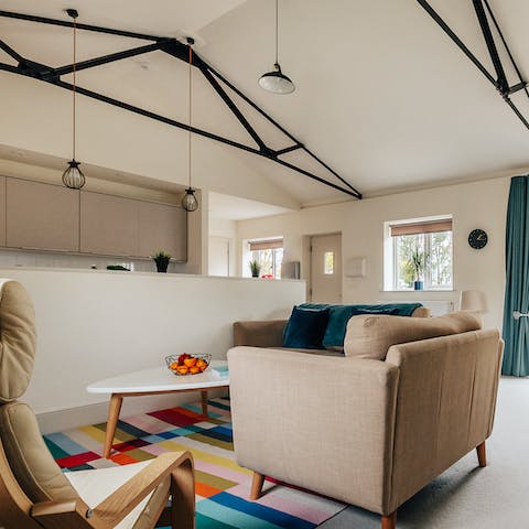 Admire the lofty living space, with its stylish modern beams