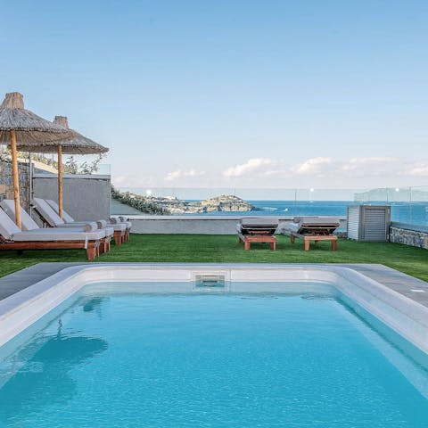 Relax poolside after opening the complimentary bottle of wine