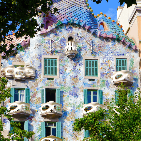 Gaze in awe at the striking facade of Casa Batlló, three minutes away