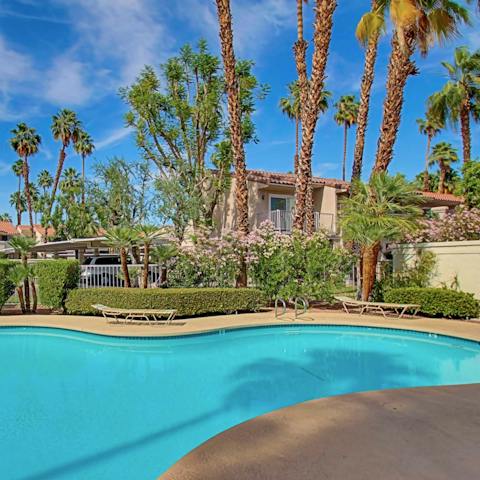 Spend afternoons diving into the palm tree-lined pool