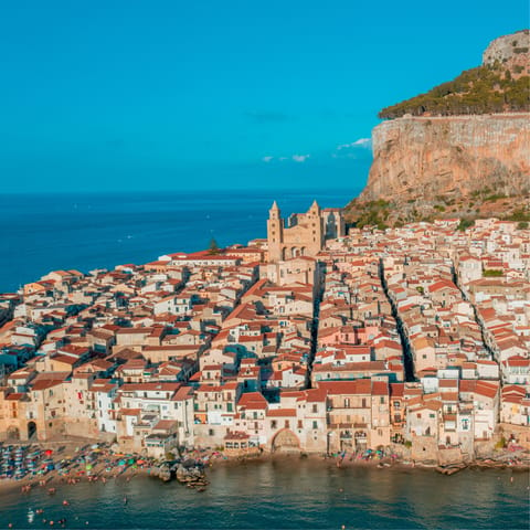 Drive up to the picturesque coastal city of Cefalu and visit its famous historic Norman cathedral