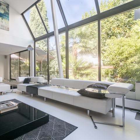 Admire the garden from the floor-to-ceiling windows