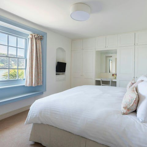 Wake up to water views in the cosy main bedroom