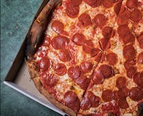 Grab a slice of New York's famous pizza at Joe's Pizza