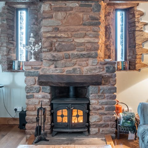Keep cosy by the wood-burner and admire the old stone of the barn