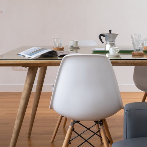 Take a seat on the Eames dining chairs and enjoy some cornetti and caffe for breakfast