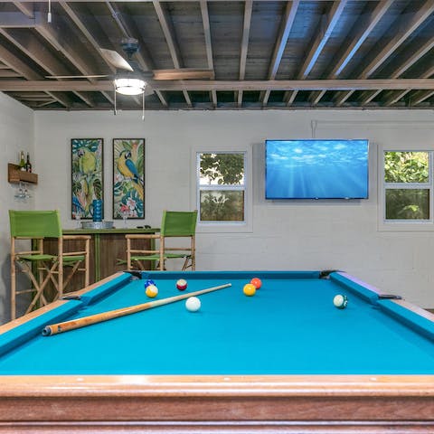 Grab a drink at the tiki bar and join your friends for a game of pool or table tennis