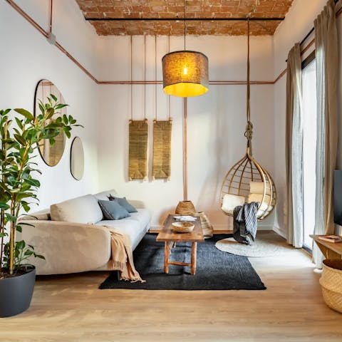 Kick back in the bright living room with its hanging chair after a busy day of sightseeing