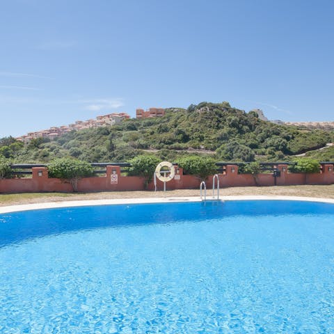 Enjoy a refreshing dip in the shared outdoor pool when the heat turns up