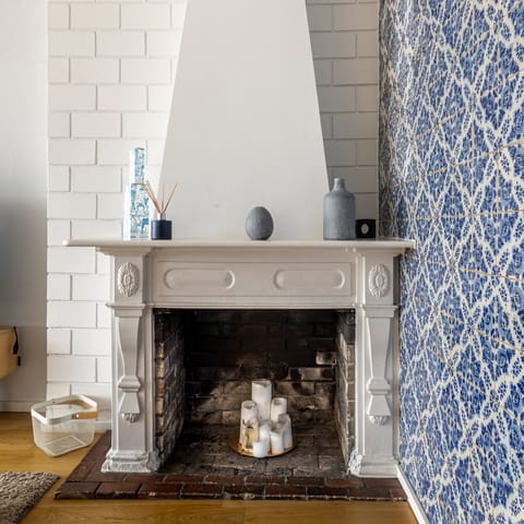 Admire the home's traditional pieces,  including the old fireplace and azulejo tiles 