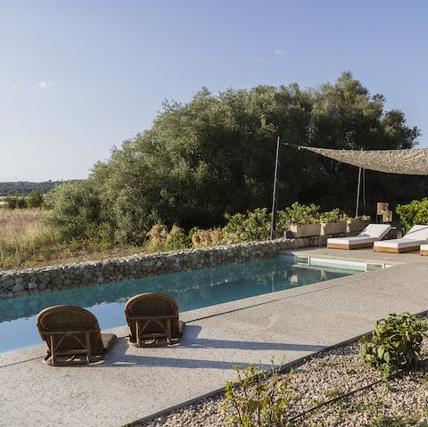 Stretch out in the sun beside the private heated pool