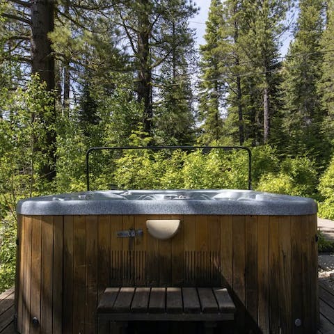 Soak in a hot tub among imposing trees