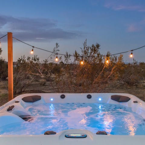 Relax in the outdoor hot tub, lined with fairy lights