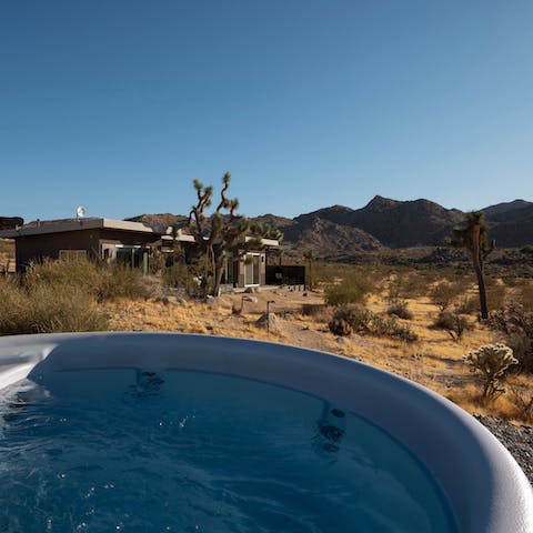 Relax in the hot tub with sweeping mountain views