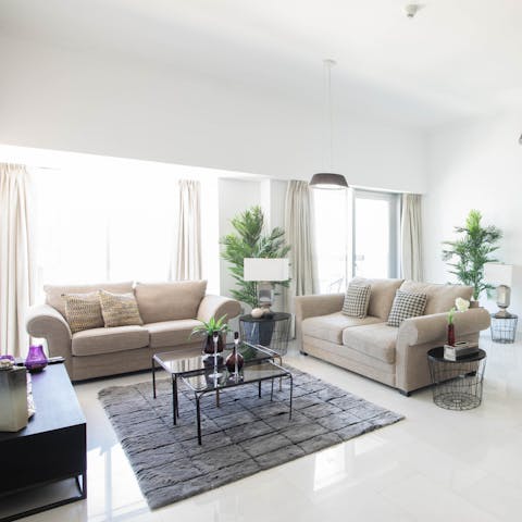 Kick back and relax in the bright living space with a cup of Arabic coffee