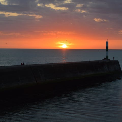 Snap photos of unforgettable sunsets from the nearby pier