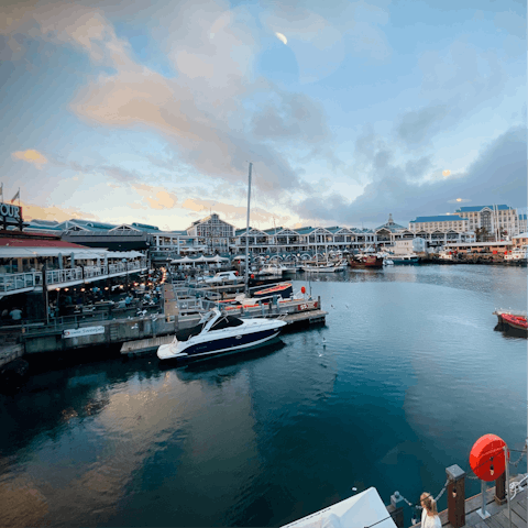 Shop and eat surrounded by harbour views at V&A Waterfront, only five minutes away