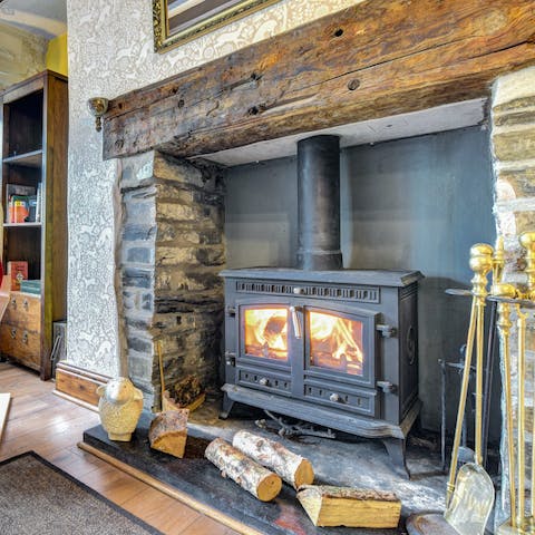Gather around the fiery wood burner for a cosy evening in