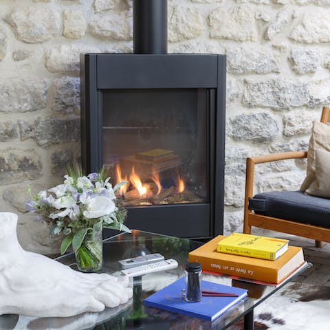 Cosy up by the fire with a glass of wine on cooler evenings