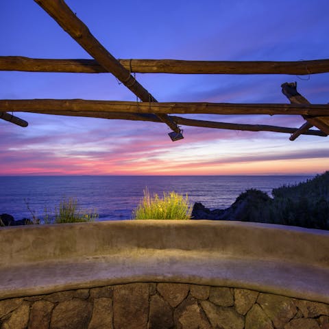 Take in the brilliant colours of a beautiful sunset from your villa's own private patio