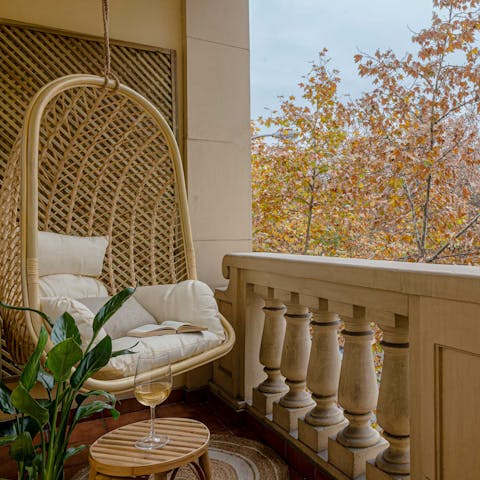 Look out over your leafy street from the suspended egg chair