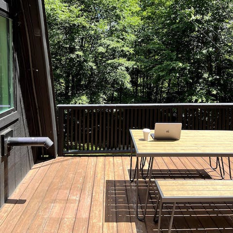 Enjoy a morning cup of coffee on the deck, surrounded by trees