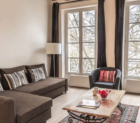 Kick back in the bright living room with a glass of wine after a day of Paris sightseeing