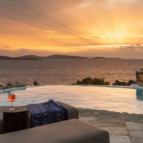 Make a cocktail sit poolside to watch the sun set over the Aegean Sea