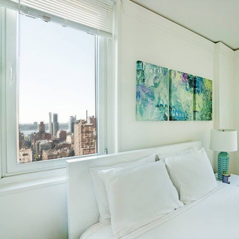 Wake up to a beautiful city landscape framed like a picture by the bedroom window
