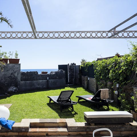 Relax and admire the  Mediterranean Sea from the lawned garden