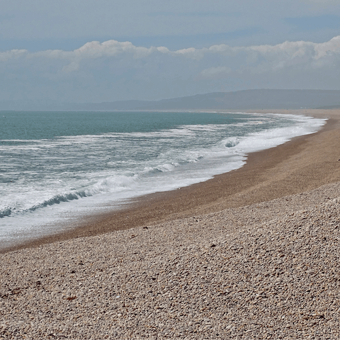 Enjoy a picnic on the pebbles of Chesil Beach, a ten-minute drive away