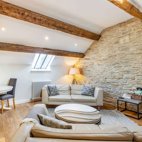 Relax with your favourite book beneath the original beams in the cosy living space