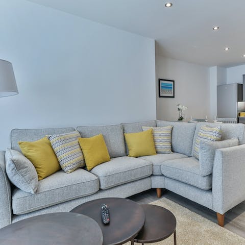Make yourself at home in the bright living area – the L-shaped sofa is perfect for family movie nights 