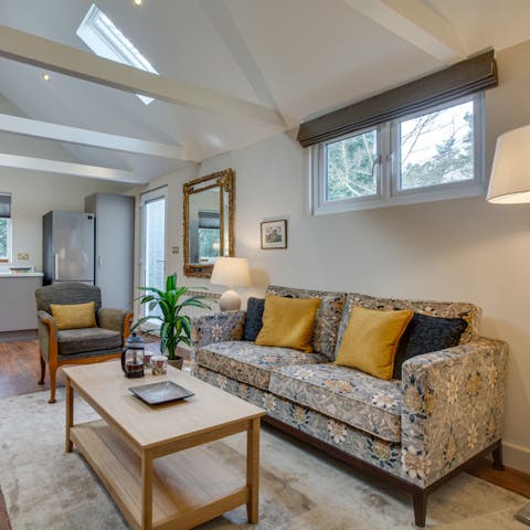 Kick back in the bright living room with a glass of wine and a good book