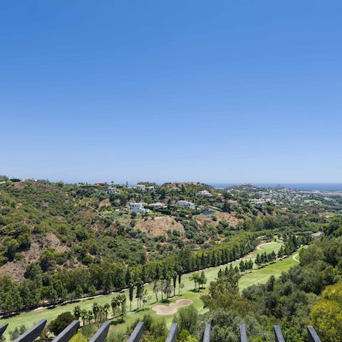 Practice your swing from the nearby golf course, seen from the home's terrace