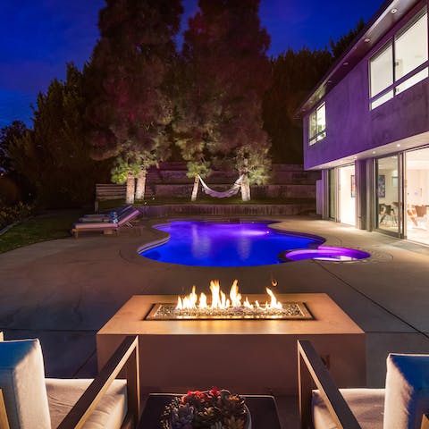Enjoy a twilight dip in the swimming pool before warming up by the fire-pit