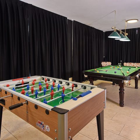 Gather in the games room with friends for billiards or table football