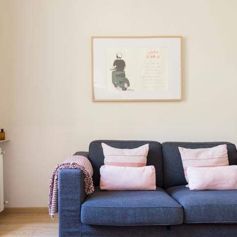 Sink into the soft navy-blue sofa in the light and airy living space