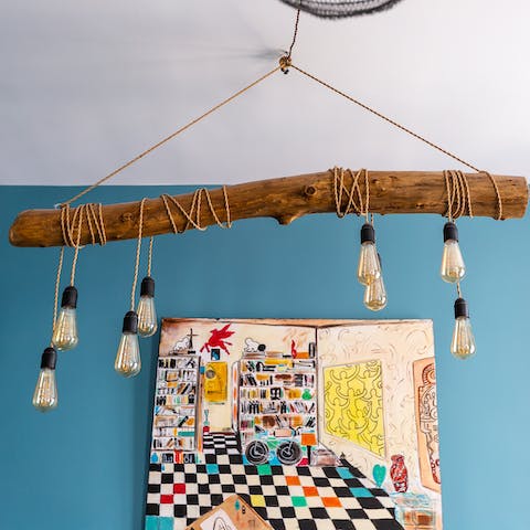 Admire the quirky light fittings and vibrant wall art