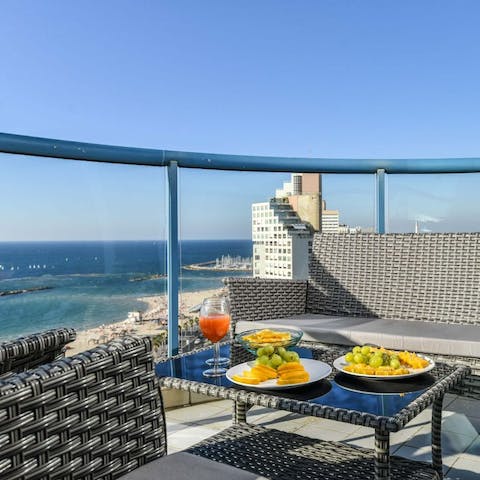 Dine alfresco on the private balcony with panoramic sea views