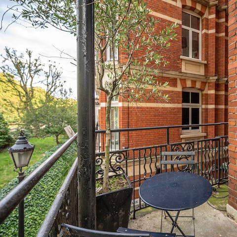 Admire the park views on the balcony, a glass of wine in hand