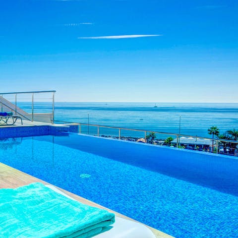 Drift beneath a clear blue sky in the private saltwater pool