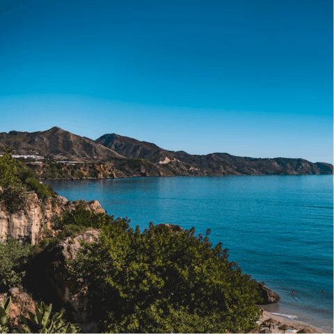 Drive along the coast to Nerja for lunch with a view