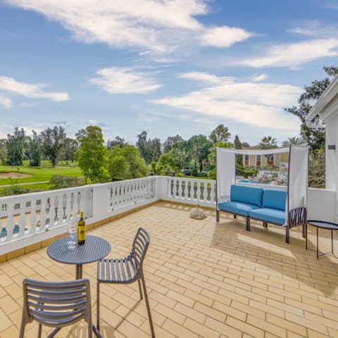 Relax with a good book on the terrace overlooking a golf course