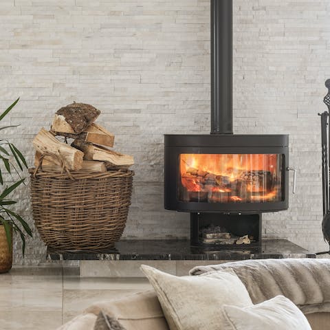 Ramp up the cosiness by putting some kindling into the wood-burning stove